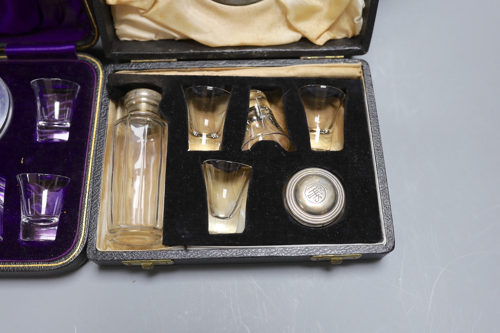 Three cased communion sets together with a mahogany box of slides